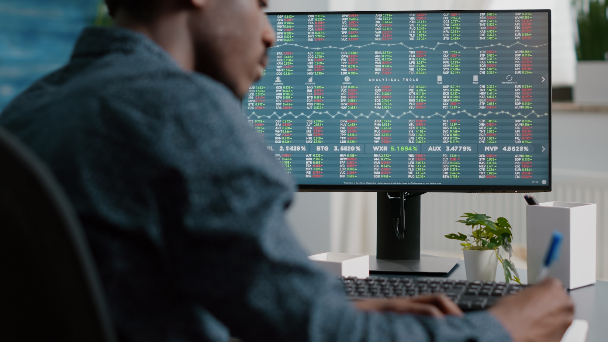 African american man looking into crypto currency stock markets trading checking stock ticker index