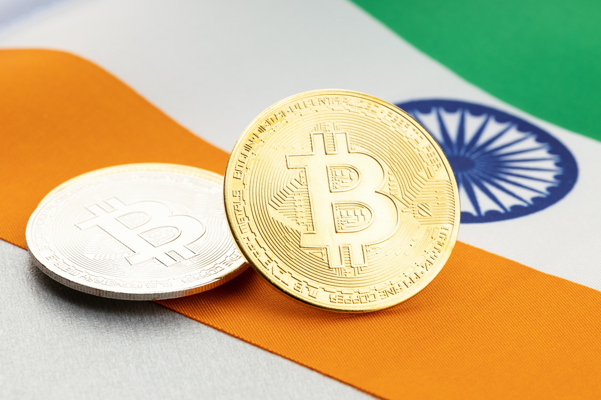 Bitcoin cryptocurrency coins on national flag of India